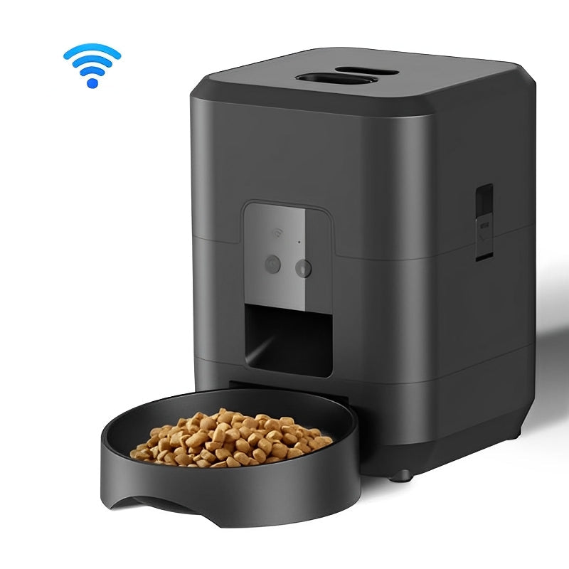 Black pet feeder with a bowl of kibble and a smartphone displaying the app interface.