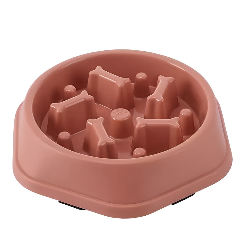 Pink slow feeder dog bowl with raised sections on a white background