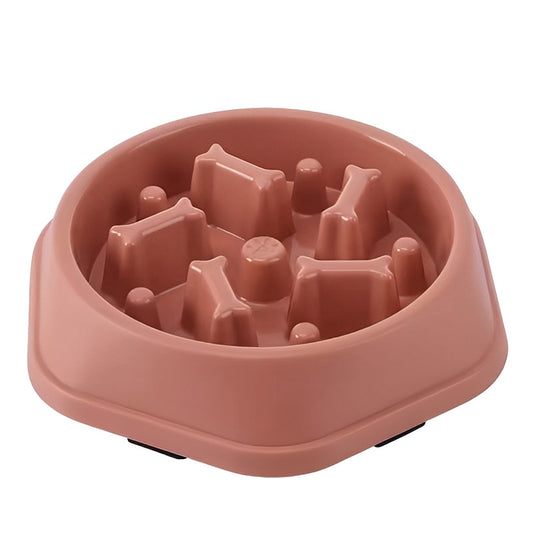 Pink slow feeder dog bowl with raised sections on a white background
